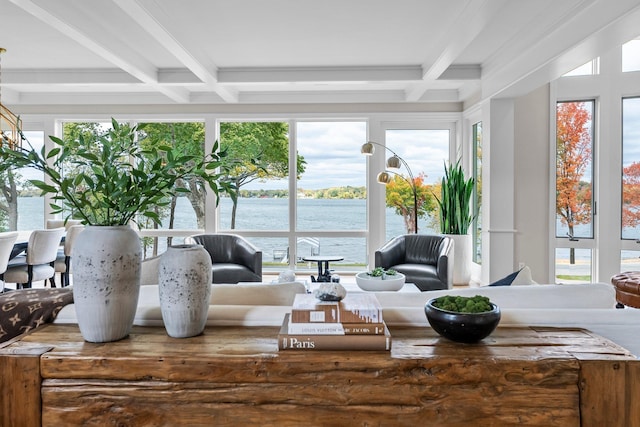 sunroom featuring coffered ceiling, beam ceiling, and a water view