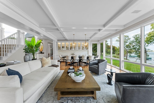 sunroom with beamed ceiling, coffered ceiling, and a chandelier