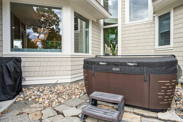 view of patio / terrace with a hot tub and a grill