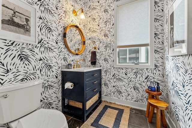 bathroom featuring vanity, tile patterned floors, and toilet