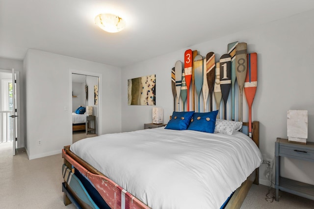 bedroom featuring light carpet and a closet