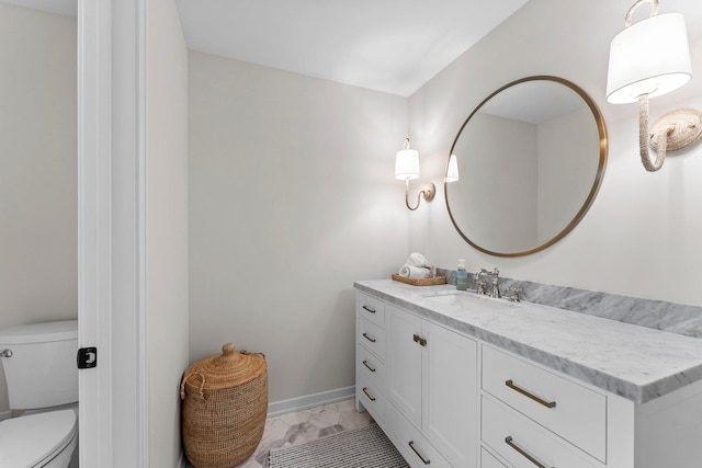 bathroom featuring vanity and toilet