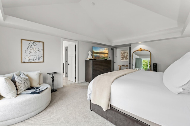 bedroom featuring light carpet and a tray ceiling