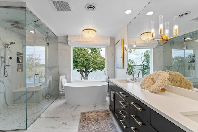 bathroom with a water view, vanity, and independent shower and bath