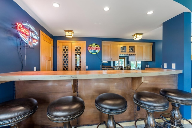 bar with light brown cabinets