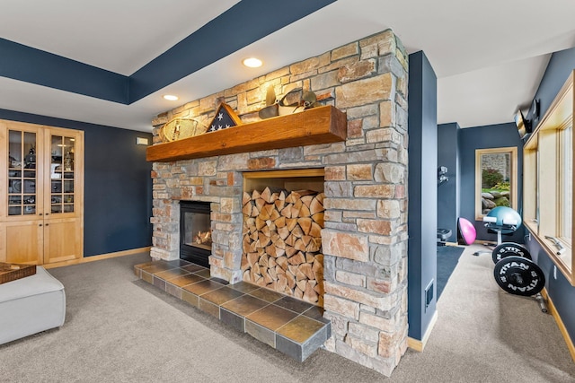 living room featuring dark colored carpet and a fireplace