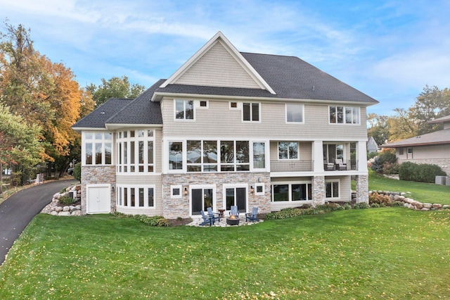 rear view of house with a yard and a patio area