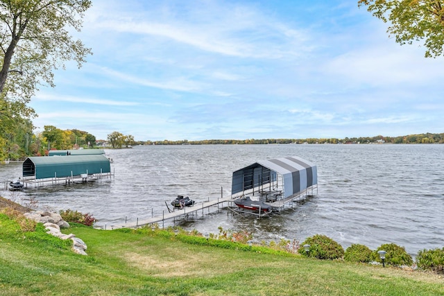 dock area featuring a water view and a lawn