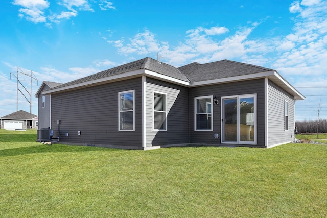 back of house featuring a yard and central AC unit