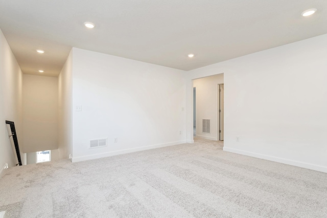 spare room featuring light colored carpet