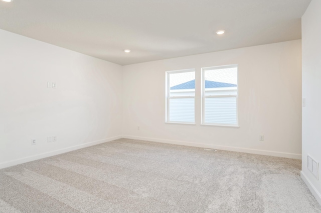 empty room featuring light colored carpet