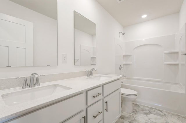 full bathroom with vanity, shower / bath combination, and toilet