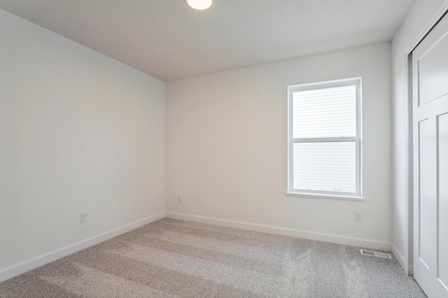 empty room with carpet flooring and plenty of natural light