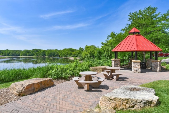 view of patio / terrace with a gazebo and a water view