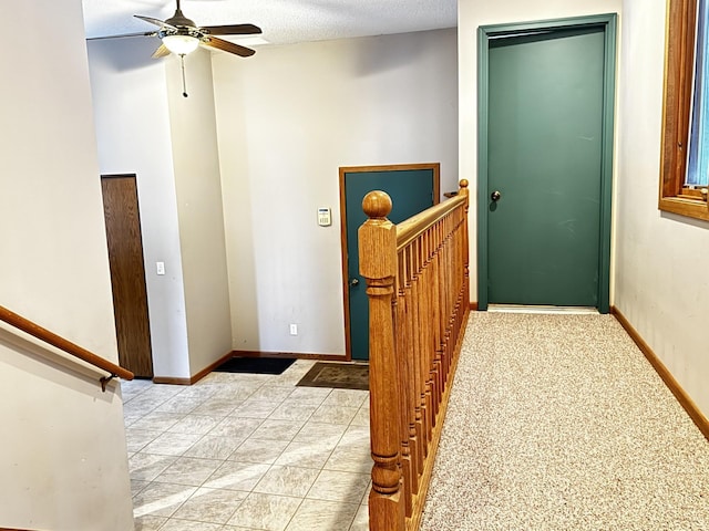 hallway with a textured ceiling