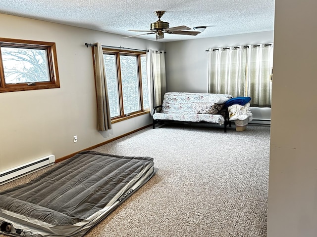 carpeted bedroom with a baseboard heating unit, a textured ceiling, and ceiling fan