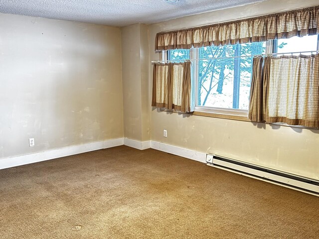 unfurnished room featuring a textured ceiling, a baseboard heating unit, and carpet