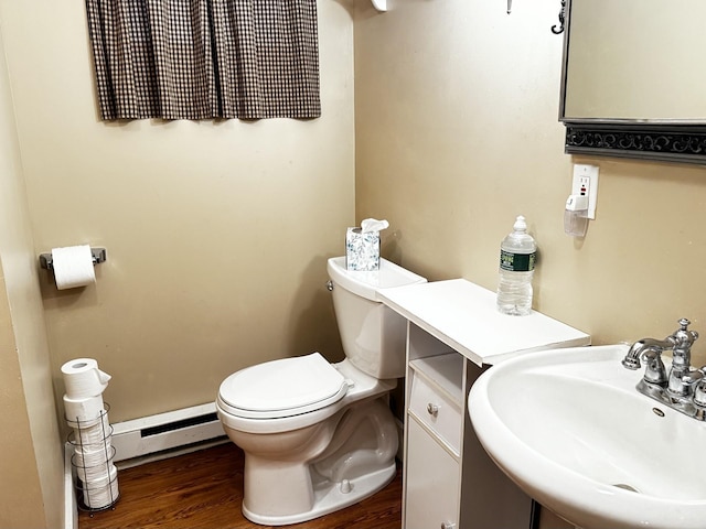 bathroom featuring sink, wood-type flooring, a baseboard radiator, and toilet