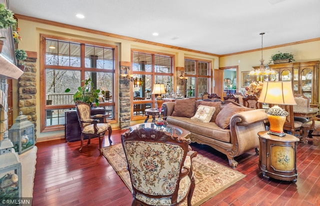 living room featuring ornamental molding, dark hardwood / wood-style flooring, and a chandelier