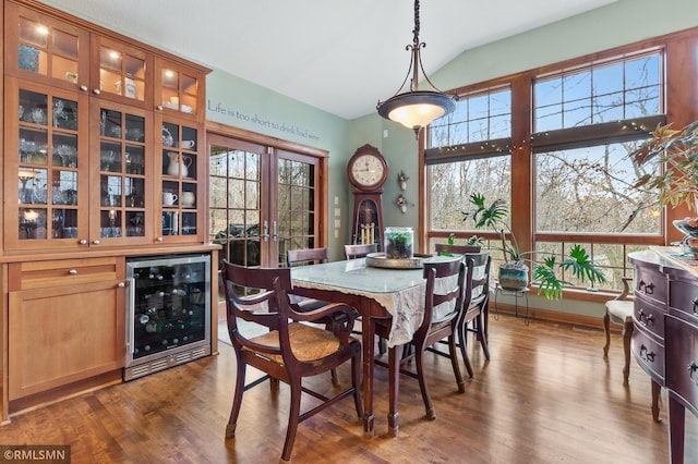 dining space featuring bar, vaulted ceiling, wine cooler, and dark hardwood / wood-style floors