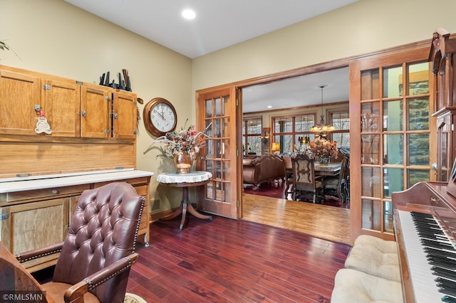 office space featuring dark wood-type flooring, french doors, and a chandelier