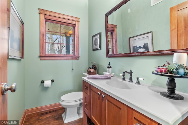 bathroom featuring hardwood / wood-style flooring, vanity, and toilet