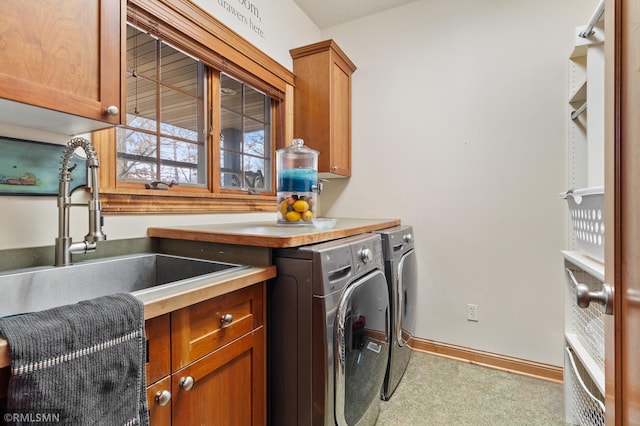 washroom featuring sink, separate washer and dryer, and cabinets