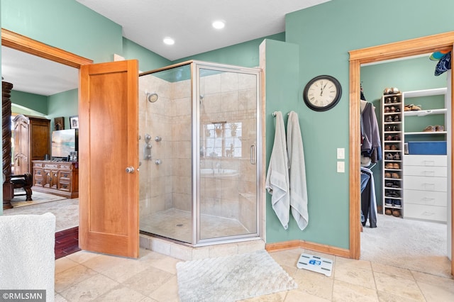 bathroom featuring tile patterned flooring and a shower with shower door