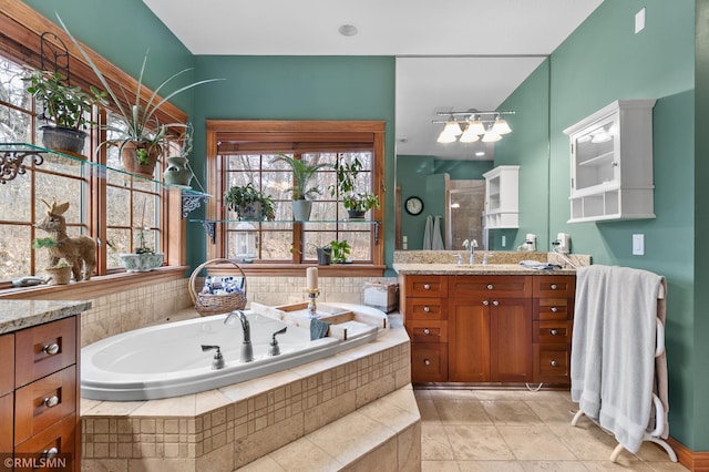 bathroom featuring vanity and a relaxing tiled tub