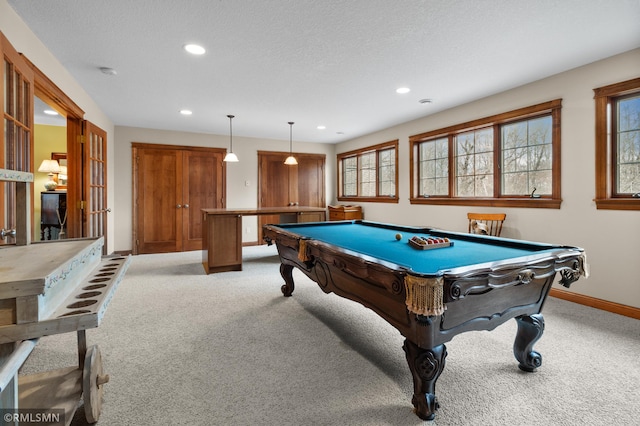 game room with pool table, a textured ceiling, and light colored carpet