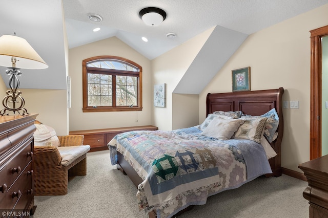 carpeted bedroom featuring a textured ceiling and vaulted ceiling