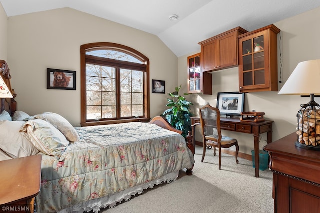 carpeted bedroom featuring vaulted ceiling