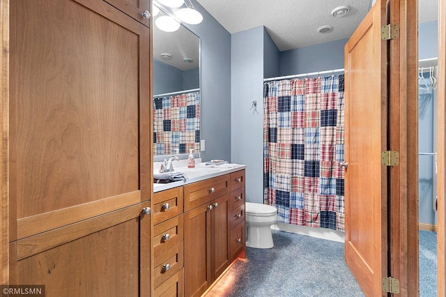 bathroom featuring toilet, vanity, and a textured ceiling