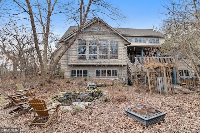 back of property featuring a fire pit