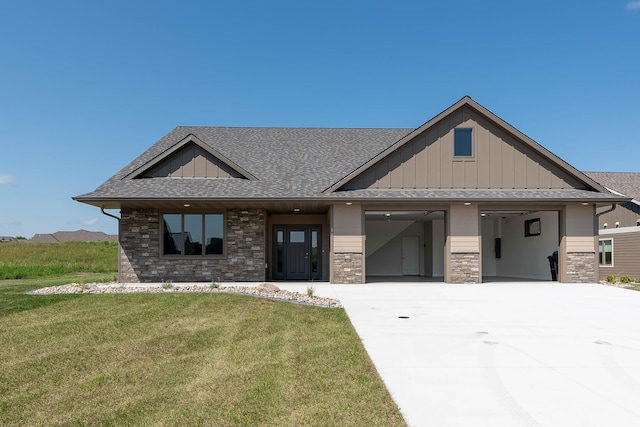 1018 Mahoe Way, Mankato, MN 56001 - view of front of property with driveway, roof with shingles, board and batten siding, a front lawn, and an attached garage