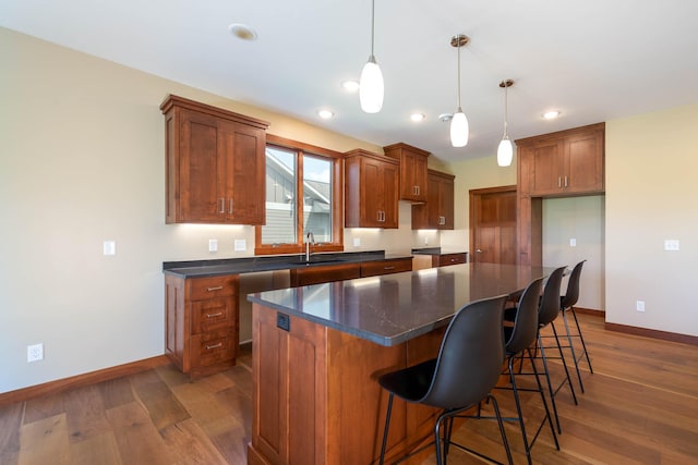 1018 Mahoe Way, Mankato, MN 56001 - kitchen with dark countertops, dark wood-style flooring, brown cabinets, and recessed lighting