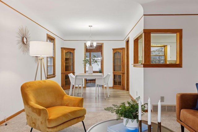 interior space with ornamental molding and an inviting chandelier