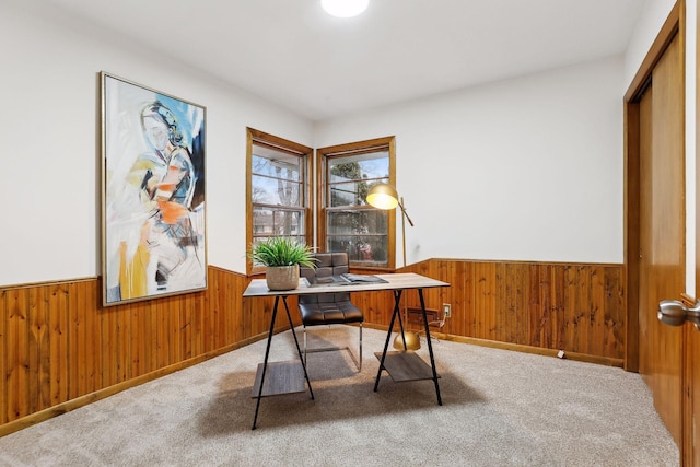 home office featuring wooden walls and carpet