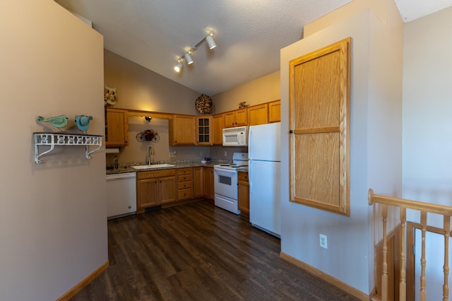 kitchen featuring lofted ceiling, sink, white appliances, dark wood-type flooring, and track lighting