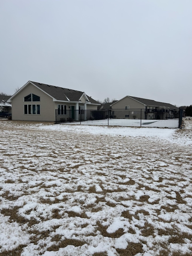 view of snow covered rear of property