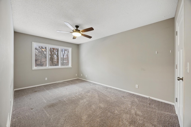 carpeted spare room with ceiling fan and a textured ceiling