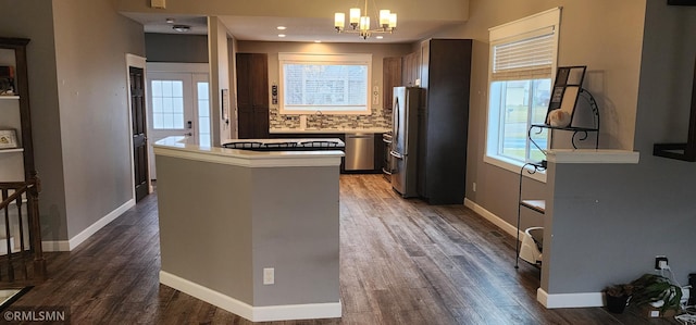 kitchen featuring decorative backsplash, dark hardwood / wood-style flooring, plenty of natural light, and appliances with stainless steel finishes