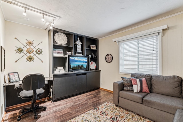 office space featuring a textured ceiling, wood-type flooring, crown molding, and track lighting