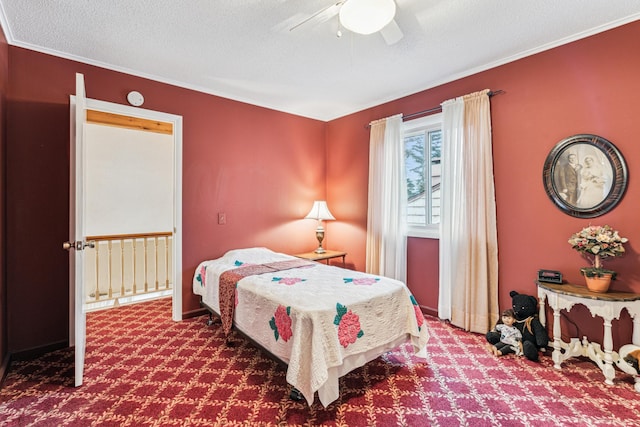 bedroom featuring a textured ceiling, carpet floors, ceiling fan, and ornamental molding