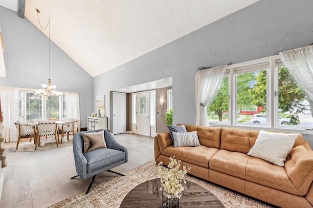 5945 Kellogg Ave, Edina, MN 55424 - living area with light wood finished floors, high vaulted ceiling, a chandelier, and plenty of natural light