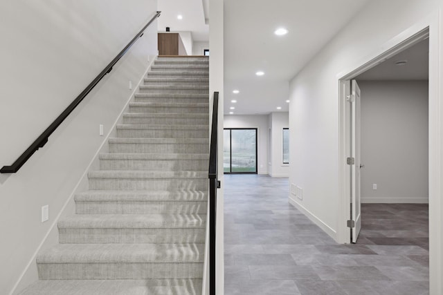 stairs featuring recessed lighting, visible vents, and baseboards