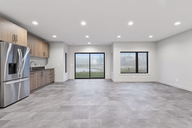 kitchen featuring recessed lighting, stainless steel fridge, and modern cabinets