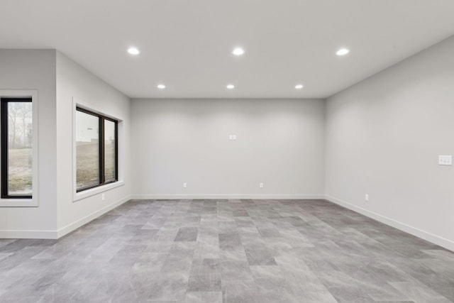 unfurnished room featuring recessed lighting and baseboards