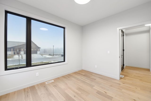 unfurnished room featuring light hardwood / wood-style floors