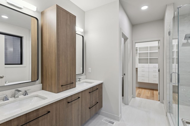 bathroom with vanity and an enclosed shower